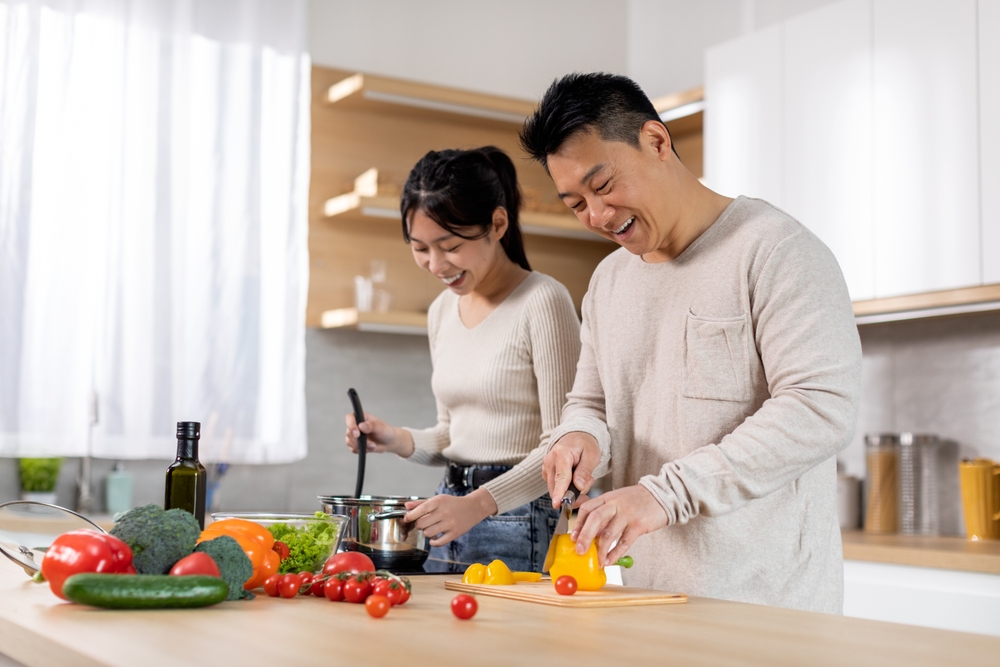 Korean man and woman cooking in a kitchen